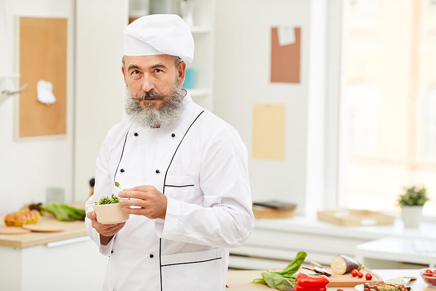 professional-chef-posing-in-kitchen-73YN8D2